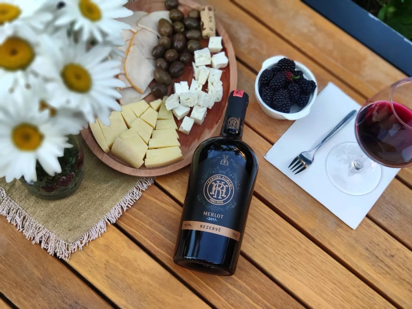 A bottle from Alimani Winery, Tirana, with cheese and olives